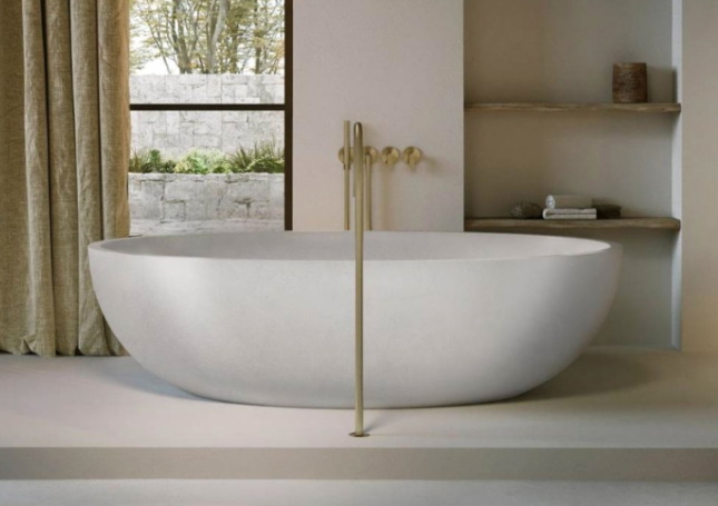 white cocoon free standing bathtub in a minimal room design in a modern luxury bathroom, gold accents